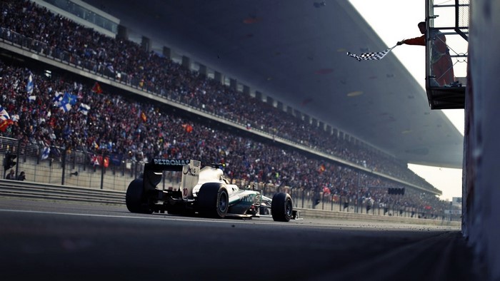 Formula 1 Race Car Crossing Finish Line with Chequered Flag