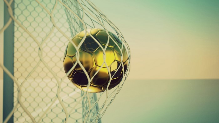 Golden soccer ball in a net