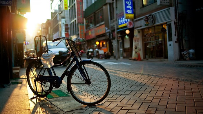 Bicycle on a brick street at sunset