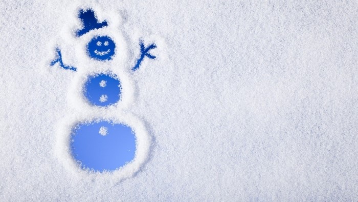 Snowman drawn in snow with blue background