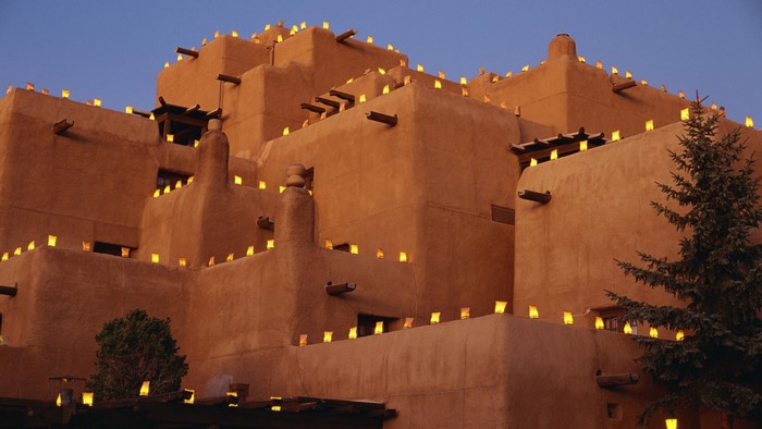 Adobe building decorated with luminarias