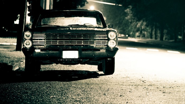 Vintage car with blank license plate at night
