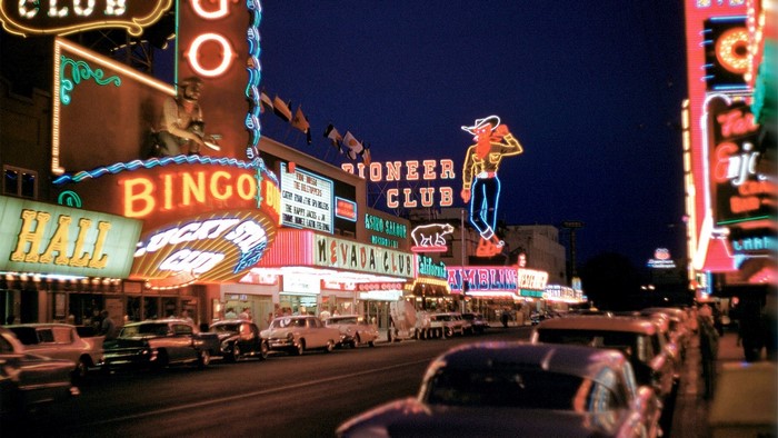 Las Vegas Strip at Night with Neon Signs and Cars
