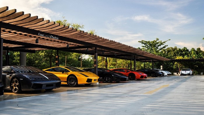 Lamborghinis parked under a wooden pergola