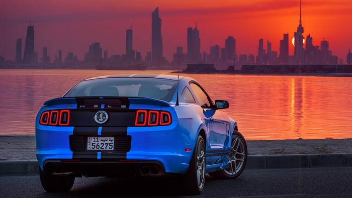 Blue Shelby Cobra GT500 with Cityscape at Sunset