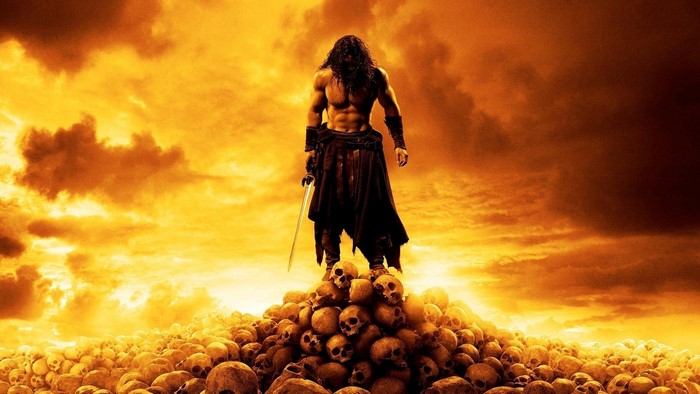 Conan the Barbarian standing on a pile of skulls