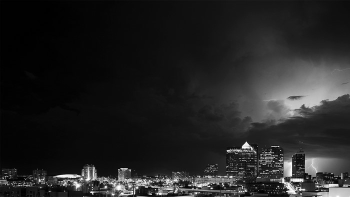 Cityscape at Night with Lightning Storm