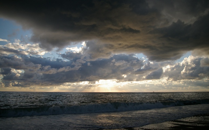 Stormy clouds over the ocean at sunset