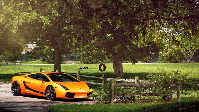 Orange Lamborghini Gallardo parked on driveway