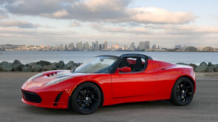Red Tesla Roadster with San Diego skyline