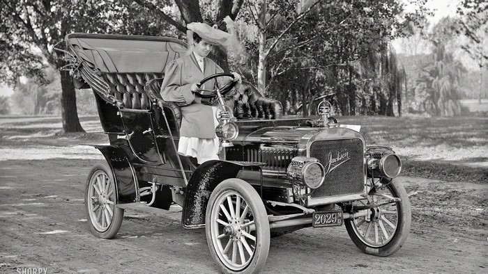 Woman in hat driving a Jackson car