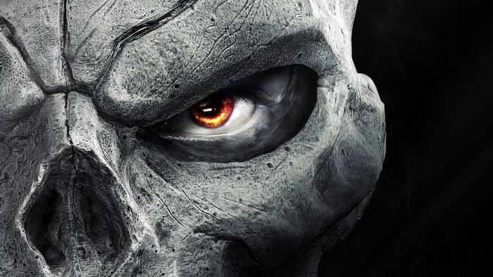 Close-up of a stone skull with a glowing red eye