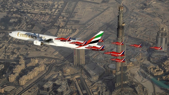 Emirates airplane flying with Red Arrows over Dubai