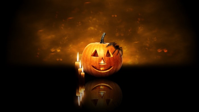 Halloween pumpkin with spider and candles
