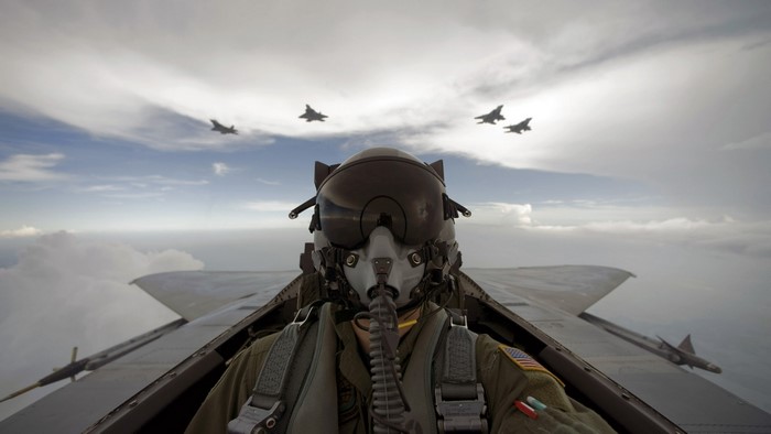 Fighter Pilot in Cockpit with Fighter Jets Flying