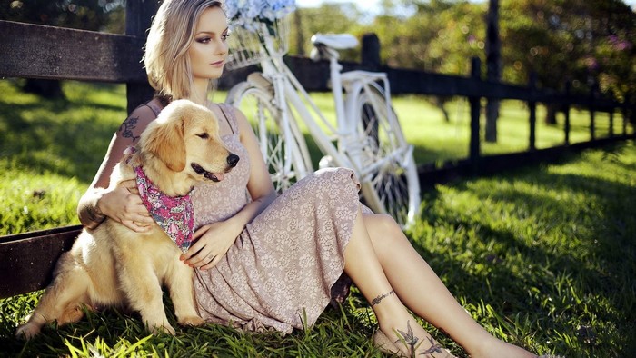 Girl with Golden Retriever dog and bicycle