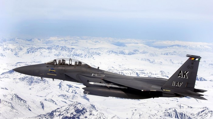 F-15 Fighter Jet Flying Over Snowy Mountains