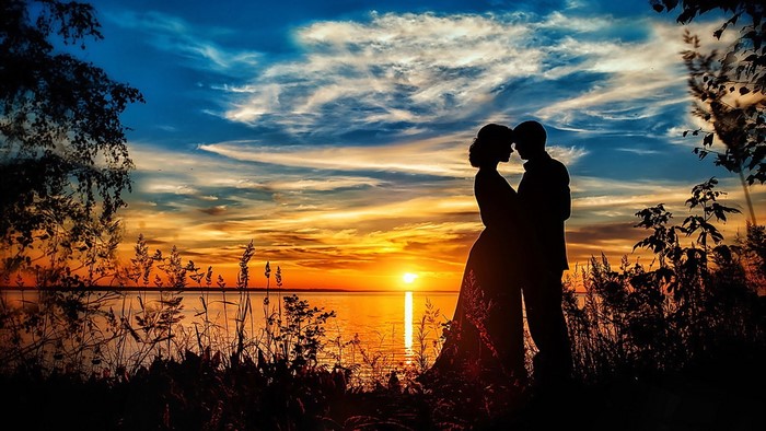 Romantic couple silhouette at sunset