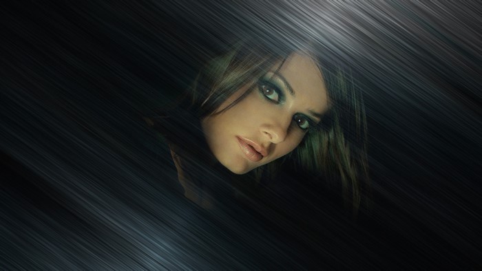 Woman with dramatic makeup and dark background