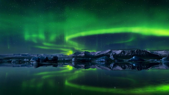 Northern Lights over Icebergs and Mountains