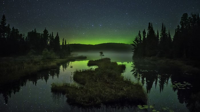 Aurora Borealis over a lake at night