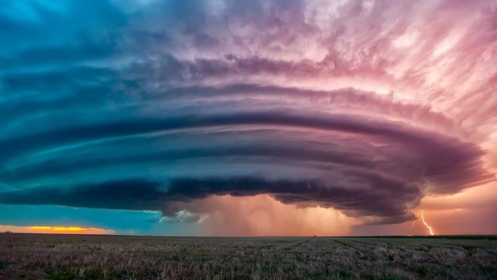 Storm clouds with lightning over a field