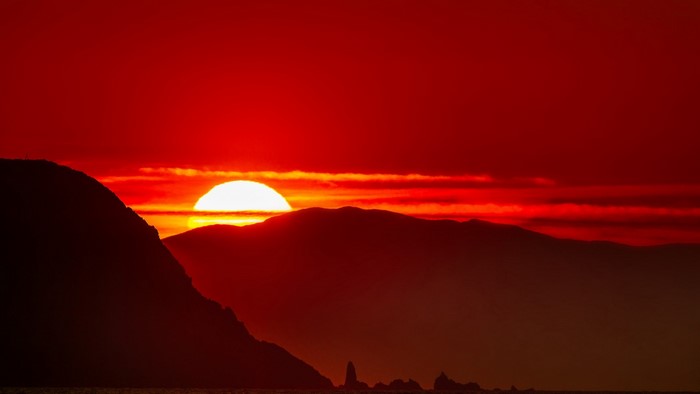Sunset over mountains and sea