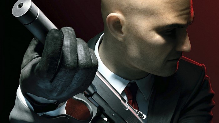 Agent 47 from Hitman Absolution holding a silenced pistol