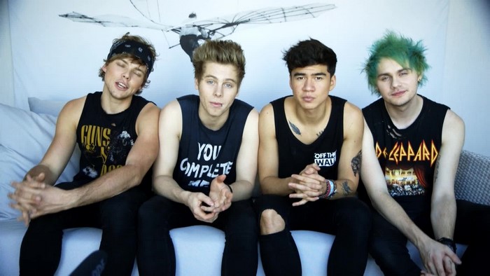 5 Seconds of Summer band members sitting