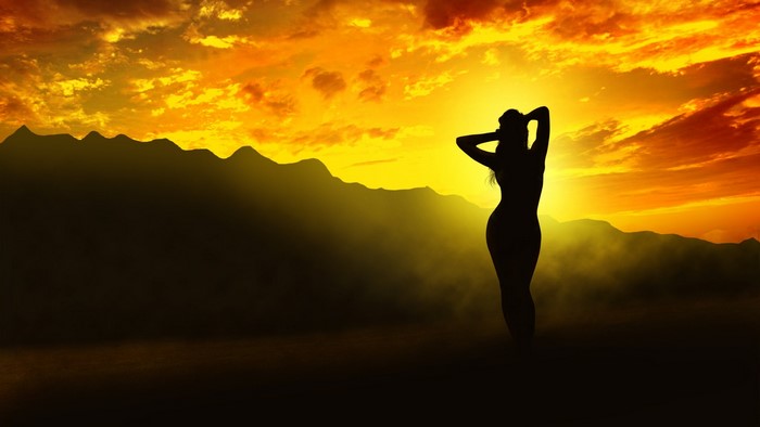 Silhouette of a woman at sunset