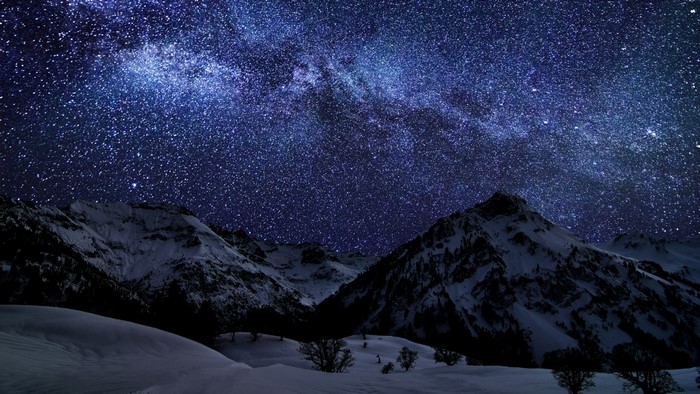 4K Beautiful night sky over snowy mountains