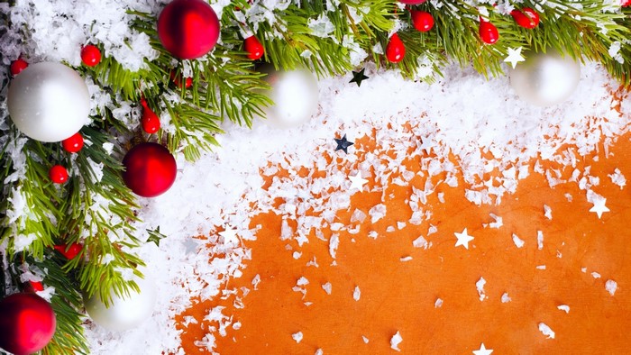 Christmas tree branches with ornaments and snow