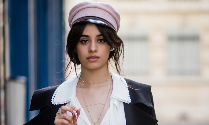 Camila Cabello wearing a pink cap and black jacket
