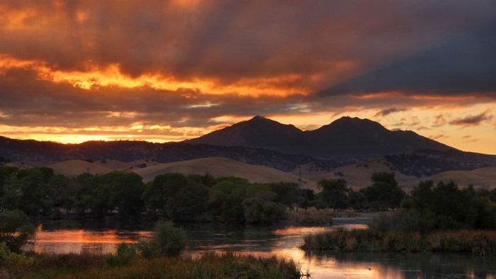 Sunset over mountains and lake