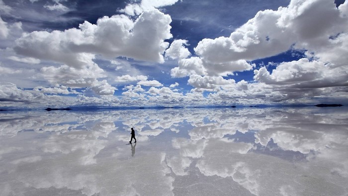 Person walking on sky reflection