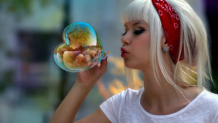Girl blowing a heart-shaped bubble