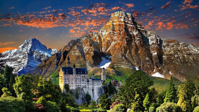 Castle in the mountains with sunset sky