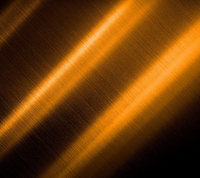 Orange brushed metal texture with diagonal light reflections