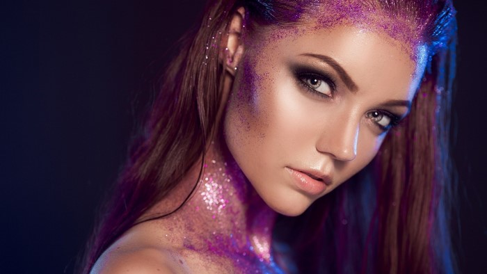 Woman with purple glitter makeup