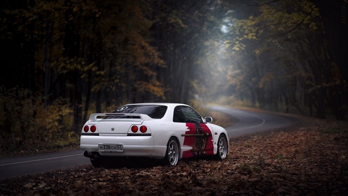 White Nissan Skyline R33 on a forest road