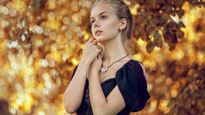 Young woman with blonde hair and a black dress