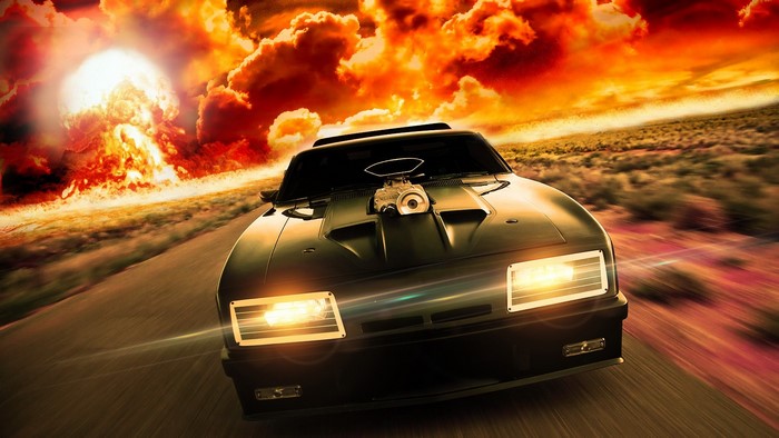 Black car with supercharger driving away from explosion