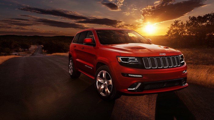 Red Jeep Grand Cherokee on a Road at Sunset