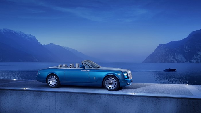 Rolls Royce Phantom convertible by a lake at dusk