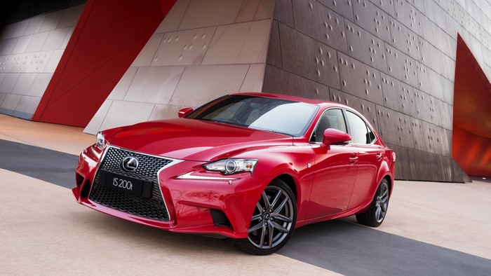 Red Lexus IS 200t parked in front of a modern building