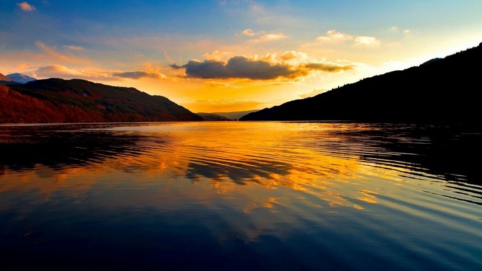 Sunset over a lake with mountains