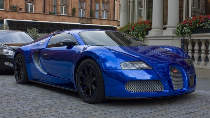 Blue Bugatti Veyron parked on cobblestone street