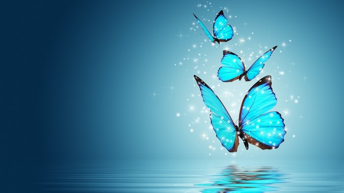 Three blue butterflies with sparkles over water