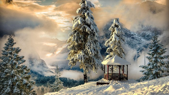 Snow-covered gazebo in a mountain landscape