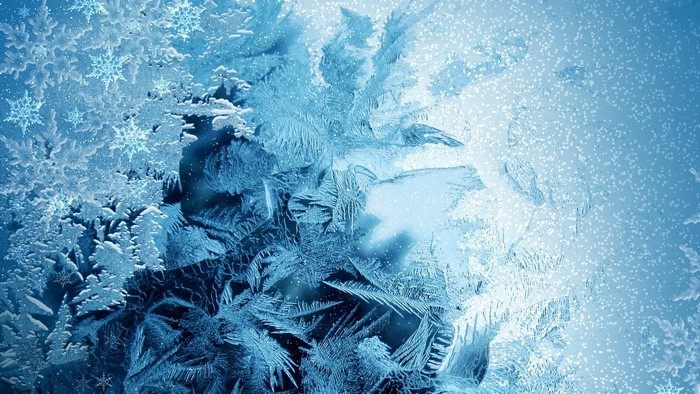 Close-up of frost patterns and snowflakes on glass